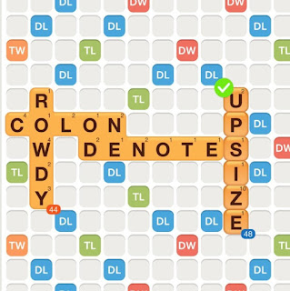 WWF game with the words colon, rowdy, and denote played on the board. The word &quot;upsize&quot; is added on the board, with the &quot;s&quot; used as a hook at the end of &quot;denotes&quot;.